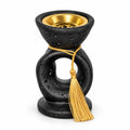 Noir Tassel incense burner in matte black with gold tassel and removable metal bowl, front view